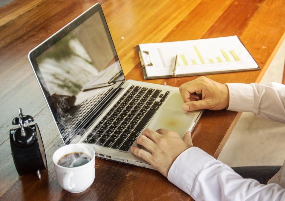 business man sitting at desk with laptop